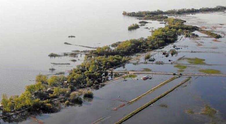 An aerial photo shows a large flooded area.