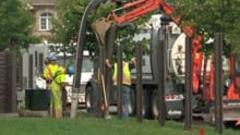 Crews removing a fence.