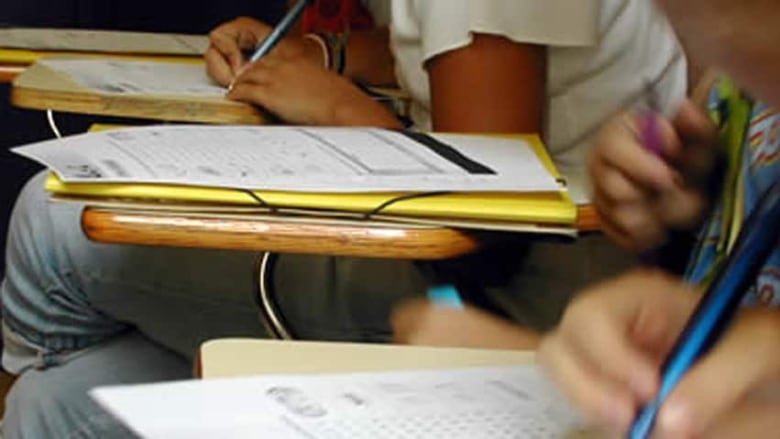 Close-up of students writing exams