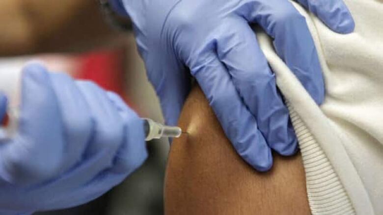 Healthcare worker providing a vaccine.