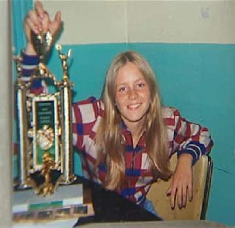 picture of a blond 16-year-old girl holding a trophy