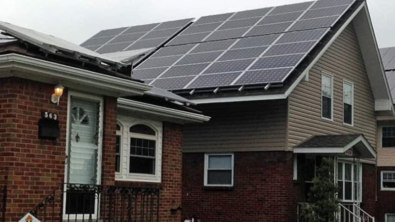 A home is pictured with solar panels.