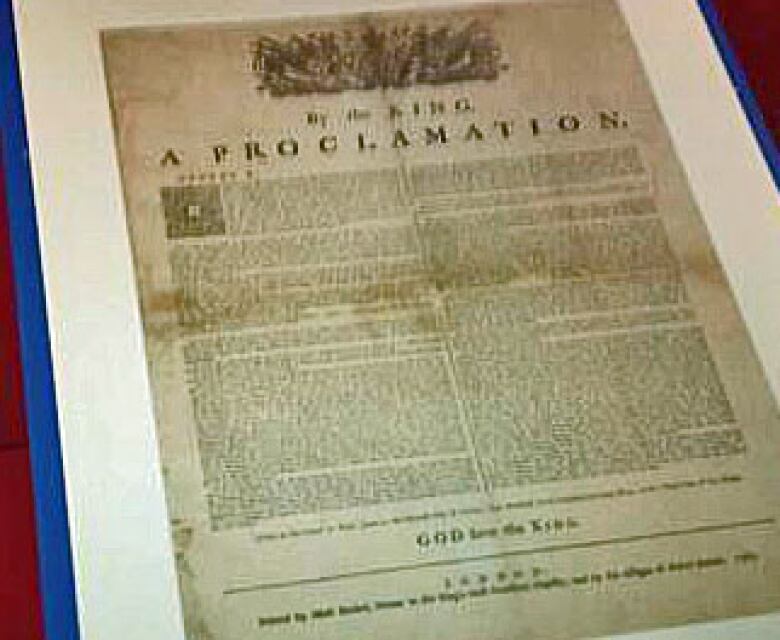 A photograph of the Royal Proclamation of 1763 under a glass case.