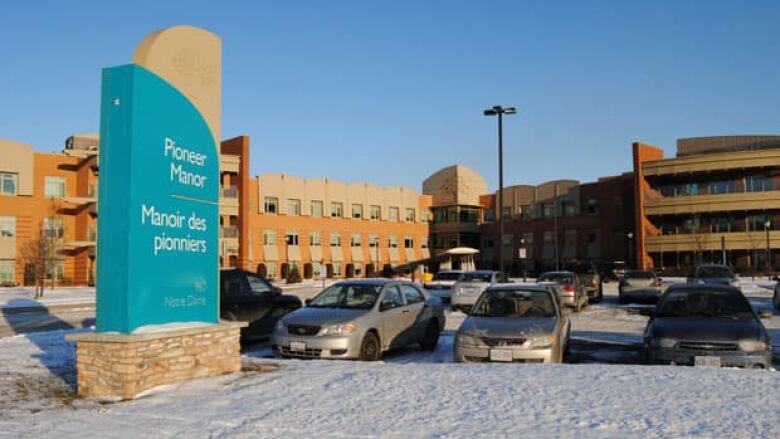 A large building with a sign in front that says Pioneer Manor.