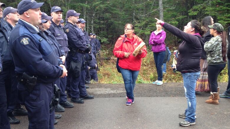 RCMP officers on the left, shale gas opponents on the right.