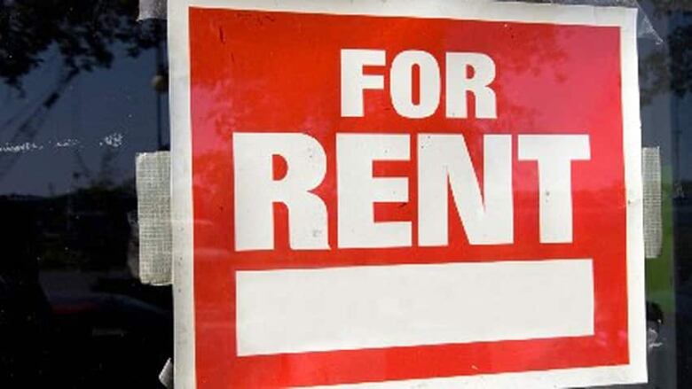 A red and white sign reading 'FOR RENT' is taped to a door.   