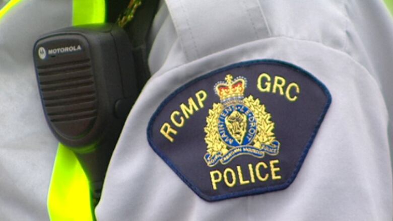 An RCMP shoulder badge that reads 'RCMP GRC POLICE', along with the RCMP logo.