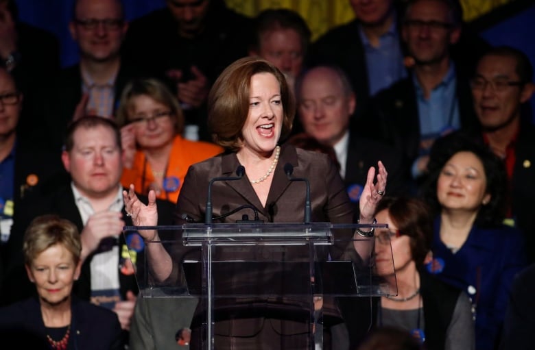 A woman speaks at a lectern