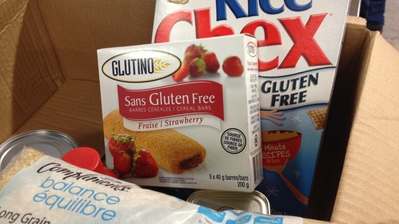 Boxes of gluten-free foods inside a larger cardboard box.