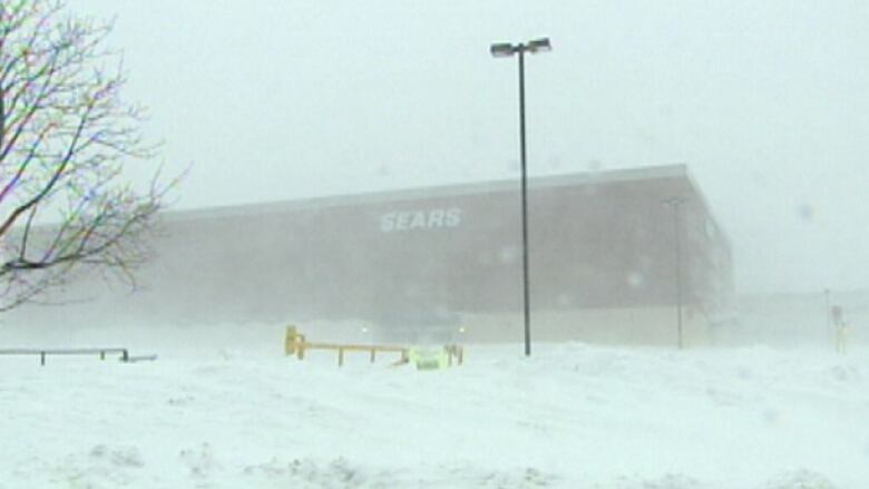 A photo of a blizzard in Halifax. The old Sears store in the Halifax Shopping Centre can be seen in the background.