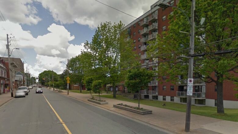 An apartment building is seen on the right, with Gottingen Street lined by parked cars on the left side.