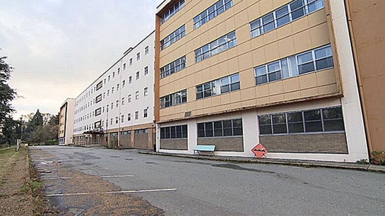 A five-storey building with a tan and white exterior.