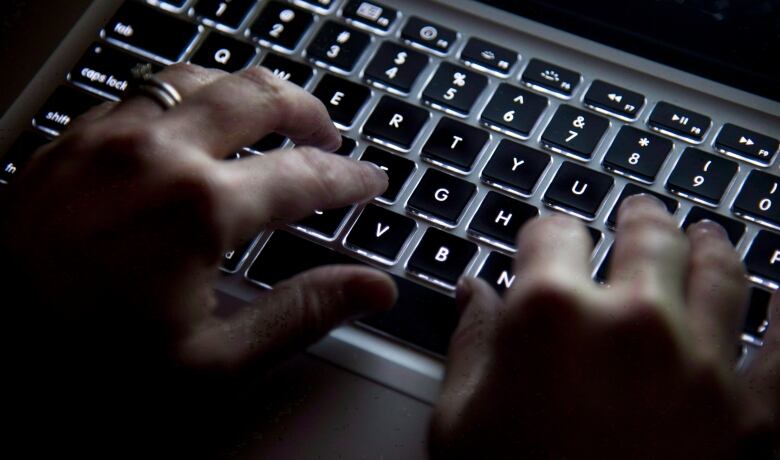 Hands are seen typing on a keyboard