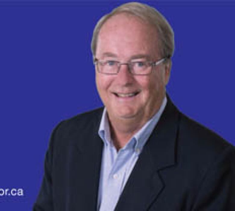 Doug McCallum poses in a headshot. He is a white man wearing glasses.