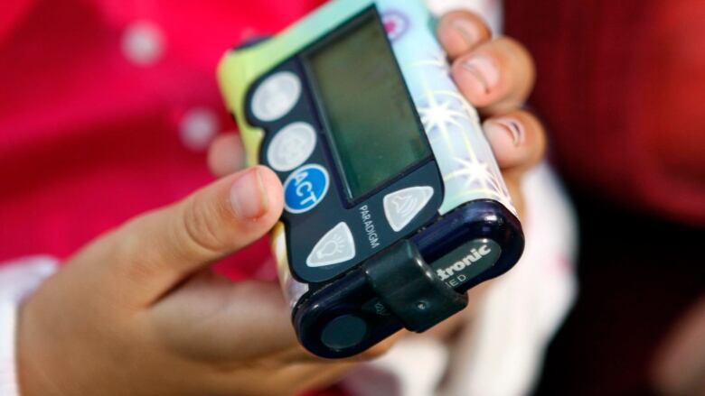 Seven-year-old Ellie Clark holds her insulin pump, which also works with an implant to display blood sugar levels, Wednesday, Sept. 12, 2007, in Grandville, Mich. Diabetes care is undergoing a transformation. Thousands of patients are switching from a few finger-pricks a day to track their disease to new sensors that keep guard around the clock. The last six months brought big boosts to the technology, as federal health officials approved the first model for children _ one that works for three days in a row _ and the longest-working version yet, a seven-day model for adults. The ultimate goal is to create an 