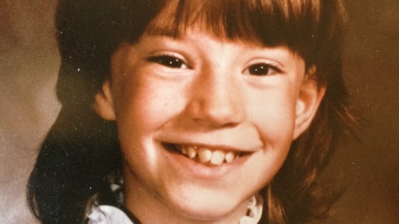 School picture of a little girl in the 1980s.