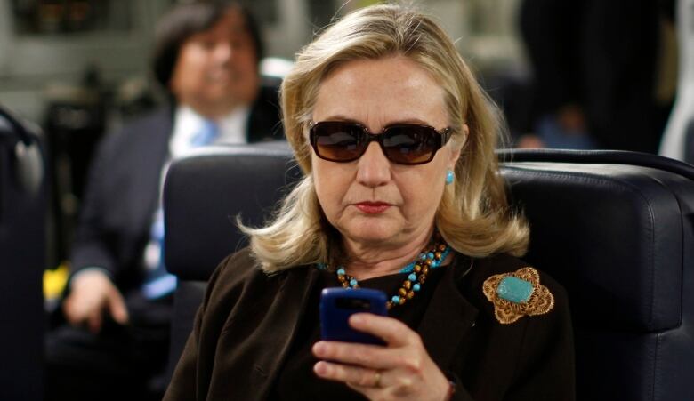 Hilary Clinton seen holding her Blackberry