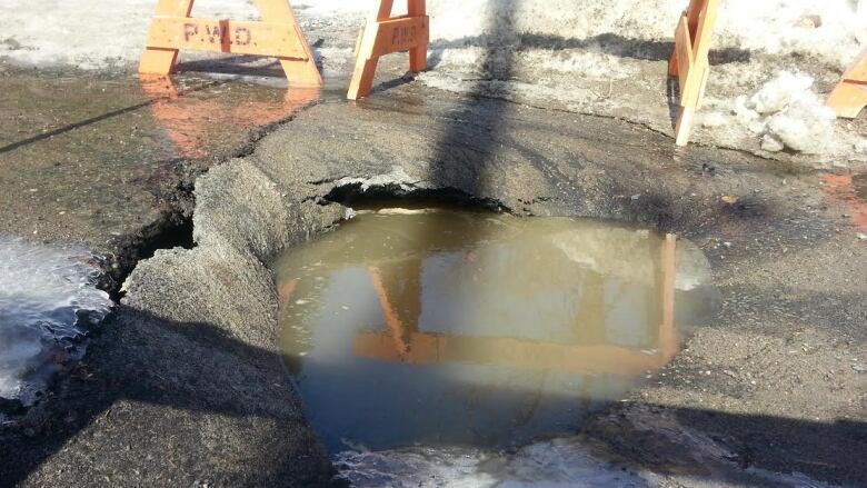 collapes road with a puddle of water