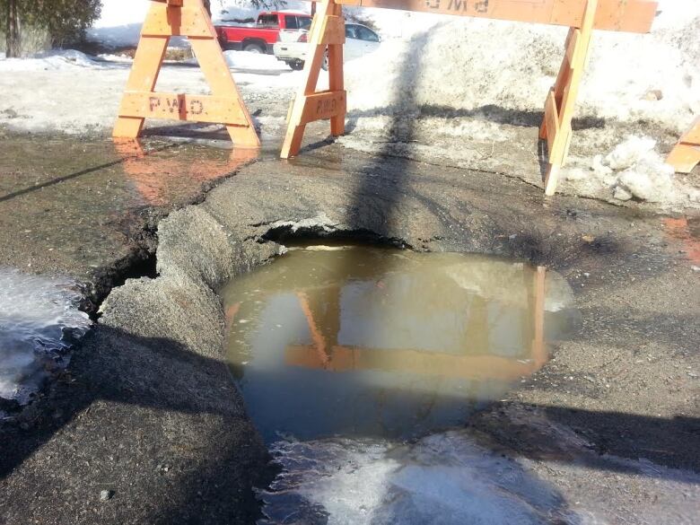 collapes road with a puddle of water