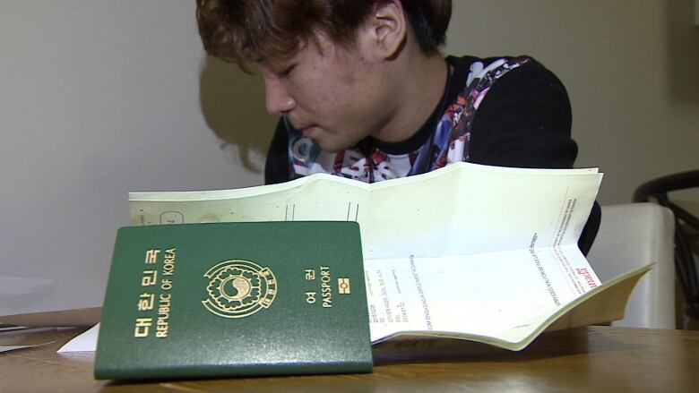 Man with Korean passport.