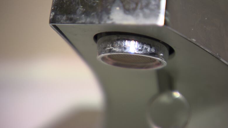 A closeup shows a water tap.