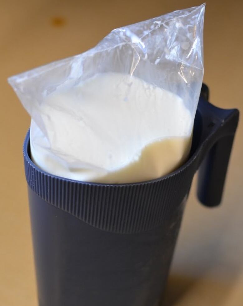 A milk bag in a plastic pitcher