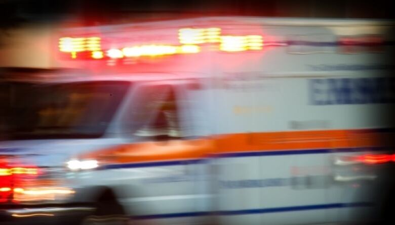 A blurry image of an ambulance in motion