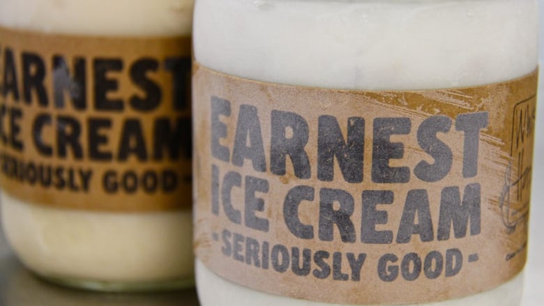 A frosty glass jar filled with off-white ice cream.