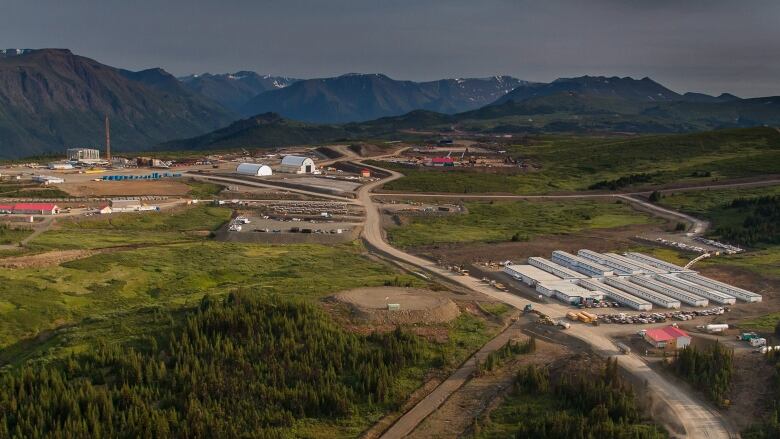 An overhead picture of a mine site, with lush green trees present all around.