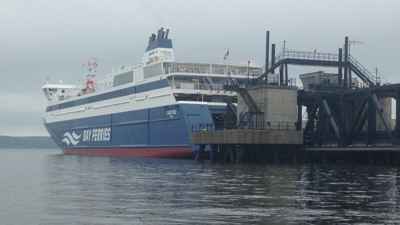 a ferry docked in a harbour on a misty day.