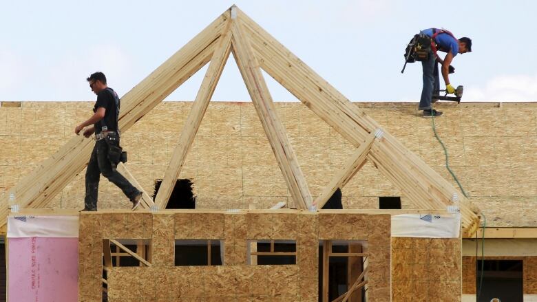 construction workers build a roof