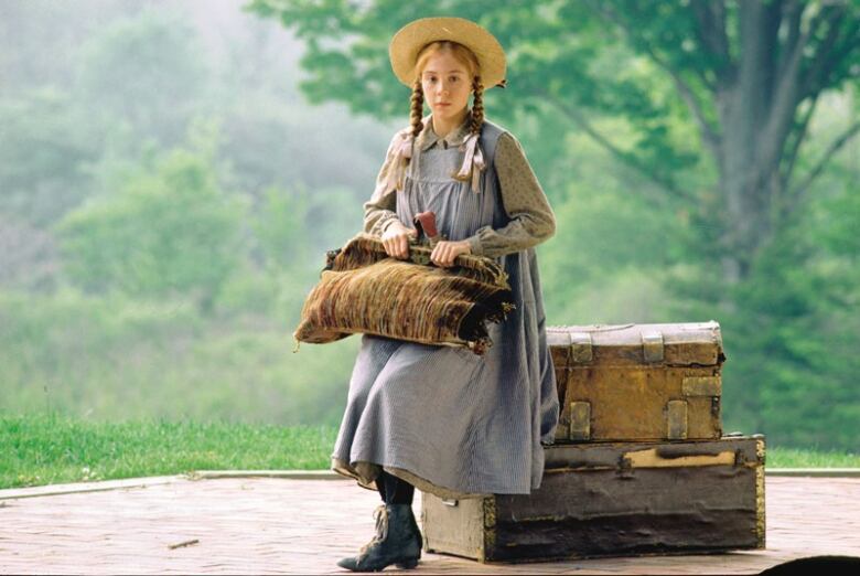 Anne Shirley waits at the train station in a screen shot from the 1985 adaptation of Anne of Green Gables.