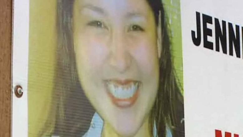 A missing person poster shows the face of a smiling young woman.