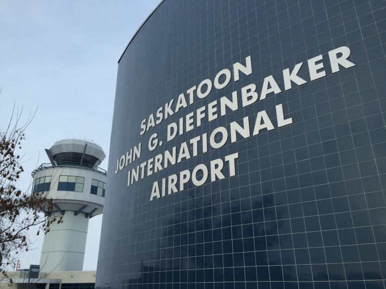 A sign outside an airport with the words Saskatoon John G. Diefenbaker International Airport.