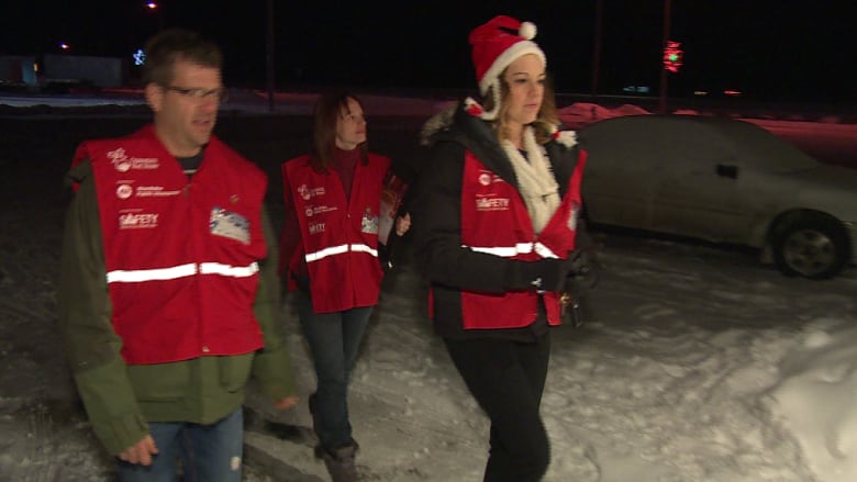 Volunteers walk outside in winter.