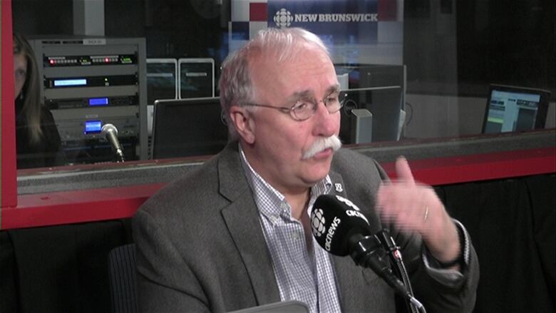 Eric Megarity speaks while sitting in a radio studio.