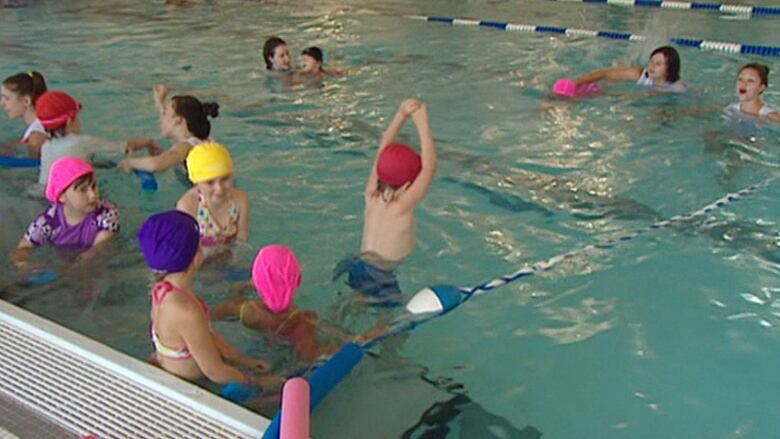 Children swim in an indoor pool