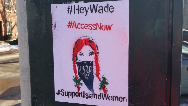 A pro-choice poster featuring an illustration of a woman's face who looks like Anne of Green Gables. The sign says #HeyWade #AccessNow #SupportIslandWomen