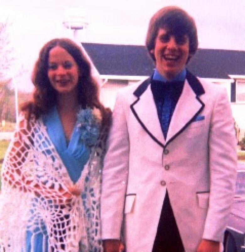 Girl and a boy dressed for prom in the 70s.