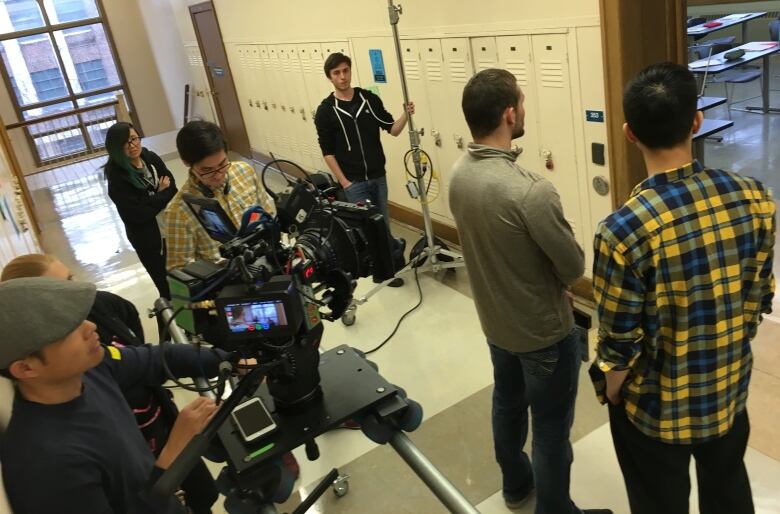 Crew members are seen working on the set of Stand Up Man at the University of Windsor on Monday, May 2, 2016.