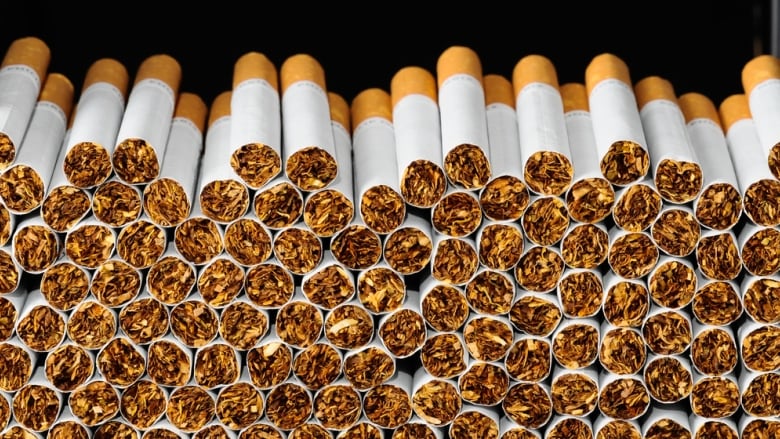 A pile of cigarettes is seen stacked.