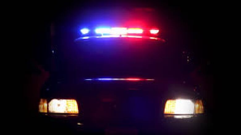 A police car's headlights at night. 