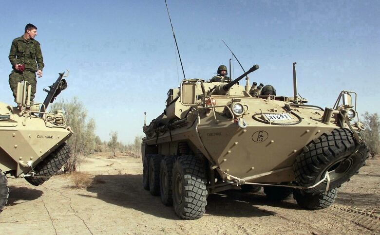 FILE--A Canadian Armed Forces Coyote armoured surveillance vehicle drives at Kandahar Airbase in Kandahar, Afghanistan Tuesday February 5, 2002.  Twenty-six-year-old Trooper Richard Renaud of Alma Quebec, a member of the 12e Regiment blinde du Canada, was killed in a blast Tuesday, Jan.15, 2008 involving a Coyote light armoured vehicle. THE CANADIAN PRESS/Kevin Frayer