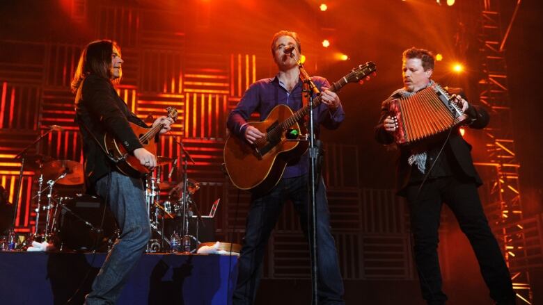 Three men on stage