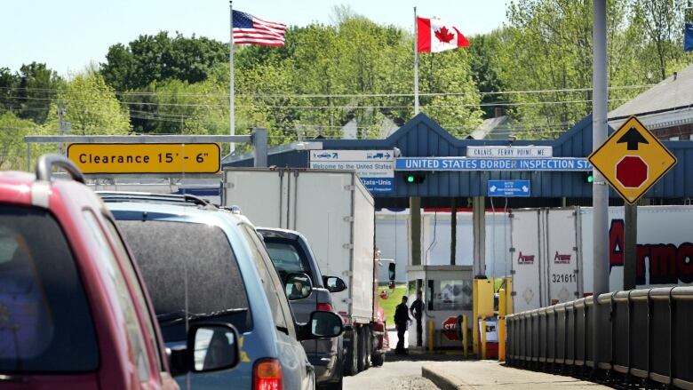 A line of cars heading into a small border crossing station in Calais