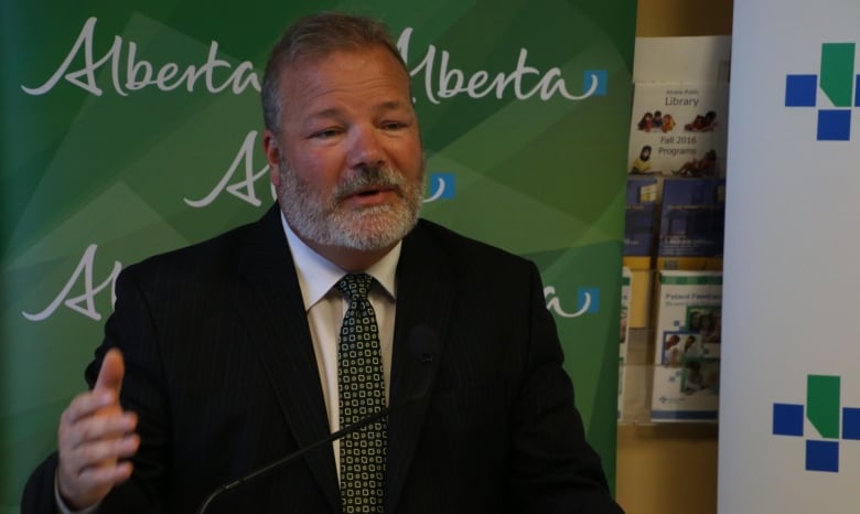 A bearded man in a dark suit speaks at a public event in this file photo.