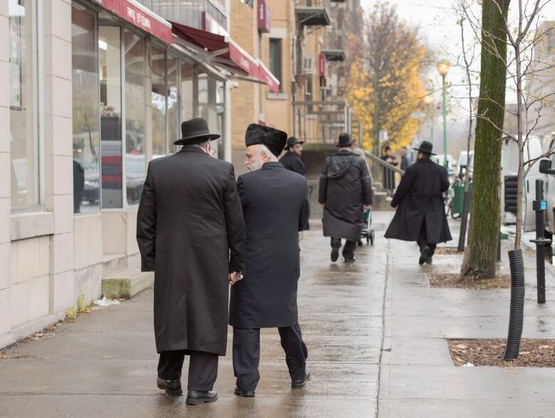 Hasidic Jews walk along Bernard Street in Outremont in Montreal. 