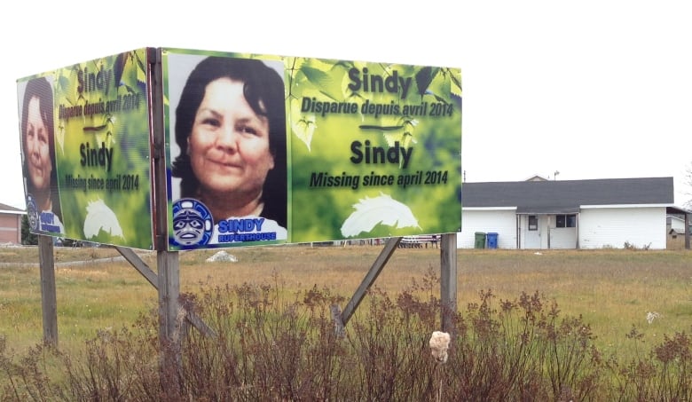 A billboard with a woman's face on it. It says Sindy missing since April 2014.