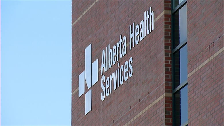 A red brick building with a sign that reads 'Alberta Health Services.'