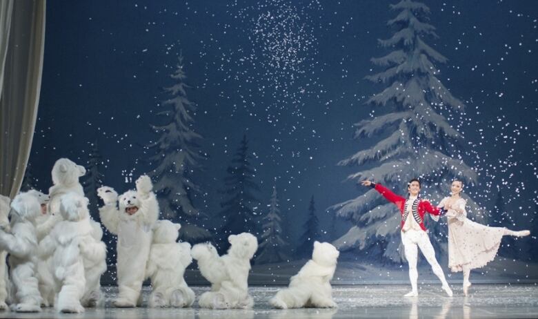 Two ballet dancers perform The Nutcracker, sharing the stage with costumed polar bears.